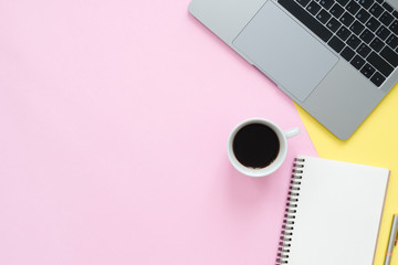 Creative flat lay photo of workspace desk. Top view office desk with laptop, blank empty notebooks and coffee cup on pastel color background. Top view with copy space, flat lay photography.