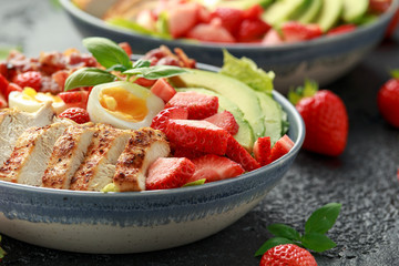 Chicken Cobb salad with strawberries, bacon, avocado and boiled eggs