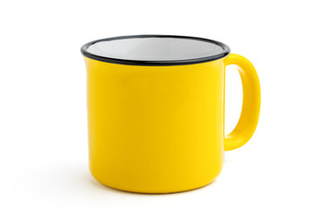 Side view of empty yellow enamel coffee mug isolated on white background.