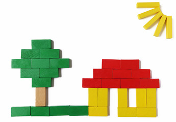 house, tree and sunbeams laid with colored blocks