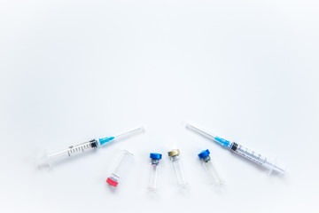 Veterinary and medical glass vials and two syringes for vaccination on a white isolated background. Liquid drug or vaccine to treat people and Pets against viruses, diseases, flu, rabies. Copy spase