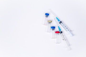 Veterinary and medical glass vials and two syringes for vaccination on a white isolated background. Liquid drug or vaccine to treat people and Pets against viruses, diseases, flu, rabies. Copy spase