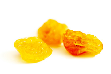 a handful of raisins on a white macro background