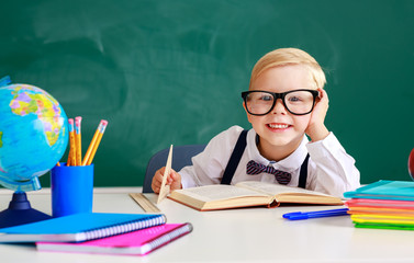 the child   schoolboy  boy student about school blackboard.