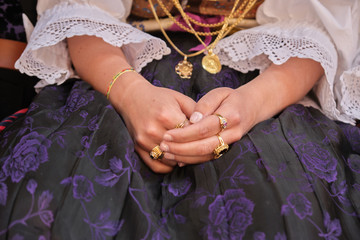 A woman dressed in typical Sardinian costume with different Sardinian ornamental golden jewels. - obrazy, fototapety, plakaty