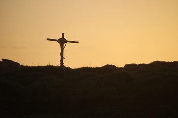 Cross and the setting sun