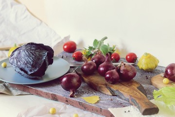 Bright vegetables of yellow and purple, flowers, spices on a wooden table, seasonal, ingredients for preparing healthy food, the season of summer, autumn