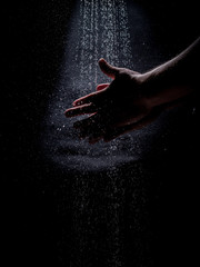 A Caucasian Man's Hands Washing Under a Stream of Water - with a Dark, Moody Background