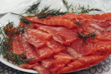 Salted red fish on a plate. Salmon with greens. Lightly Salted Sandwich Salmon