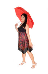 Chinese woman standing with a red umbrella in the studio