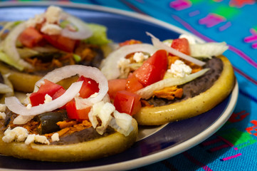 Mexican sopes made with chicken tinga and black beans