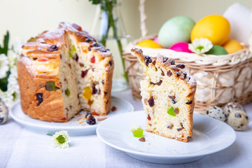 Craffin (Cruffin) with raisins and candied fruits. Easter Bread Kulich and painted eggs. Easter Holiday. Close-up.