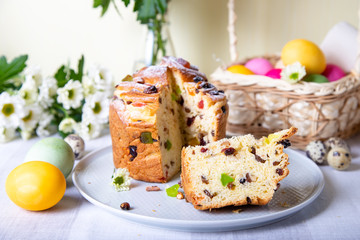 Craffin (Cruffin) with raisins and candied fruits. Easter Bread Kulich and painted eggs. Easter Holiday. Close-up.