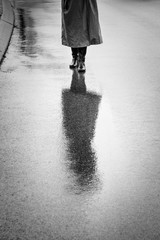 Person in Raincoat Reflected on Wet Street