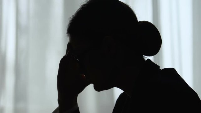 Female employee clutching head, suffering migraine and depression, overwork