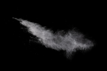 White powder explosion on black background. Colored cloud. Colorful dust explode. Paint Holi.