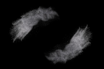 White powder explosion on black background. Colored cloud. Colorful dust explode. Paint Holi.