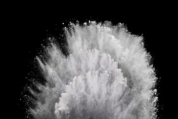 White powder explosion on black background. Colored cloud. Colorful dust explode. Paint Holi.