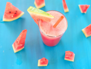 Glass of watermelon smoothie on a wooden blue table. Selective focus