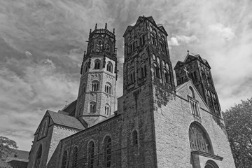 St. Ludgeri catholic church in Muenster, Germany against cloudy sky in black and white