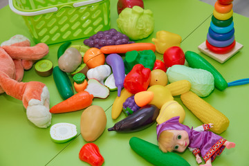Fake fruits and vegetables .Plastic childrens toys in the form of fruit and vegetables . Toy fruits and grasszs .