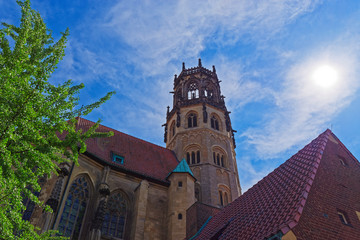Fototapeta na wymiar Tower of St. Ludgeri catholic church against blue sky on sunny day