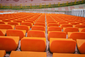 Front of the orange seats on the stadium