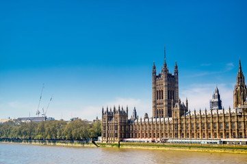 Fototapeta na wymiar British Parliament along the River Thames on a sunny day in London, UK.