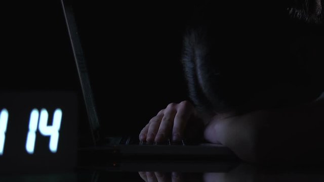 Woman sleeping on laptop keyboard, tiresome work on nightshift, burnout till 4am