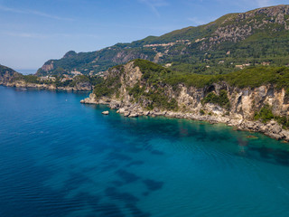 Fototapeta na wymiar Rocky coastline at Corfu island. Turquoise clear water. Aerial summer photo from drone. Greece.