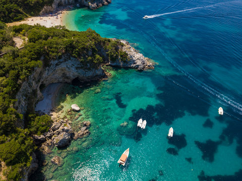 Boats near rocky coastline at Corfu island. Turquoise clear water. Aerial summer photo from drone. Greece. © umike_foto