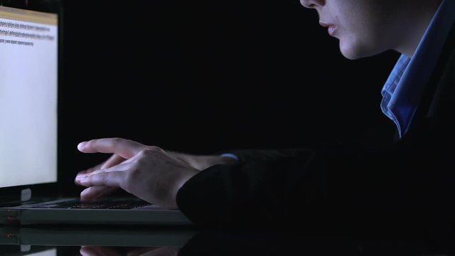 Freelance system administrator typing program code, working on night shift