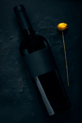 Red wine bottle mockup on stone. Black label
