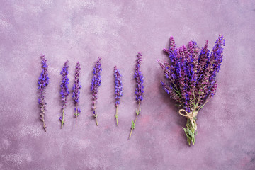 Flower arrangement and a bouquet of purple flowers on a beautiful background. View from above, flat lay.