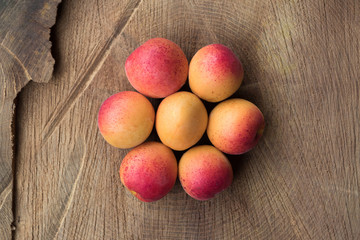 Organic apricots on wooden background, flat lay photography