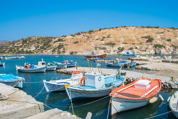 Traditional colorful fishing boats in Saint Nicolas (Agios Nikolas) bay in Kimolos island, Cyclades, Greece