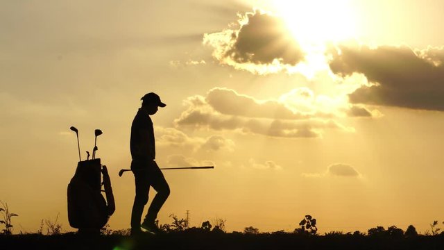 Silhouette The male golfers are practicing outdoors footage 4K