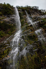 Waterfall at Milford sound. Fjordland. new Zealand. Fog. Misty
