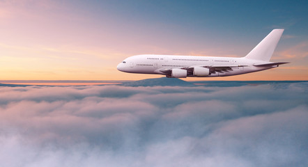 Fototapeta na wymiar Huge two-storey passengers commercial airplane flying above dramatic clouds. Travel and business concept.