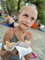 girl on the beach eating lunch