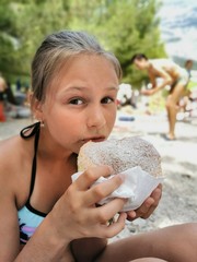 girl with donut on the beach