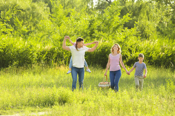 Fototapeta premium Happy family walking in park on summer day
