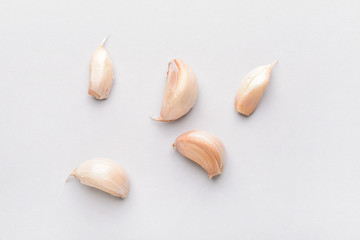 Garlic cloves on light background
