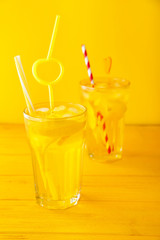 Glass of tasty summer cocktail on color background
