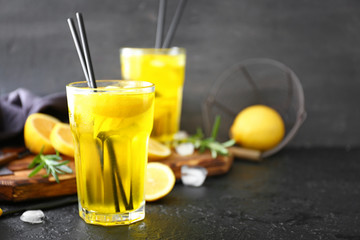 Glass of tasty summer cocktail on dark table