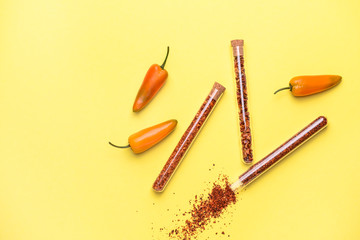 Dry pepper in tubes on color background