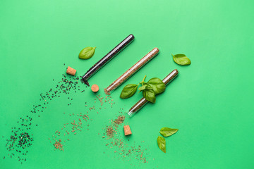 Assortment of spices in tubes on color background