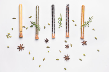Assortment of spices in tubes on white background