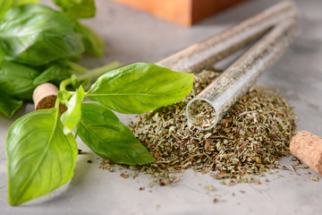 Dry spices in tubes on grey table