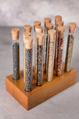 Assortment of spices in tubes on grunge background